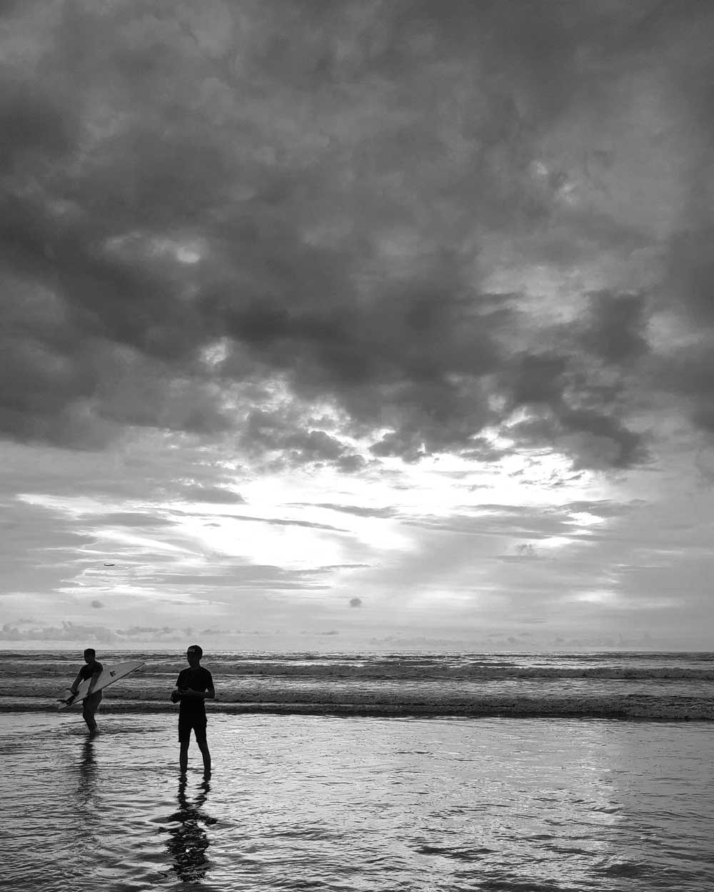kuta-bali-black-white 2 guys on Kuta Beach, Bali, Indonesia